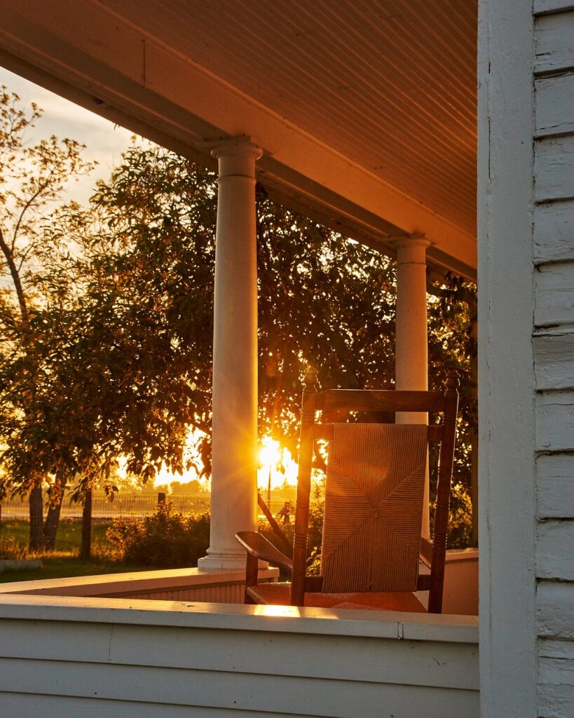 A front porch with a rocking chair facing the sunrise